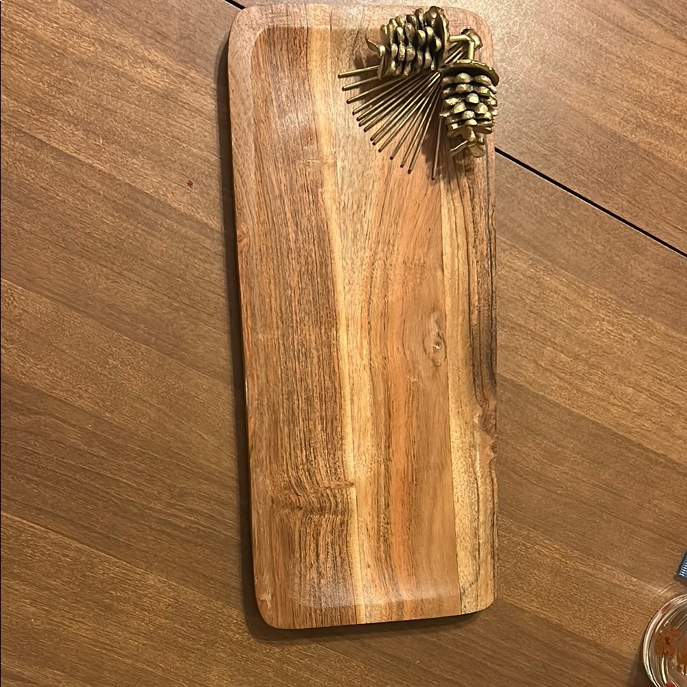 Natural Wood Serving Platter with gold metal pinecone decoration. 14.75” x 6.25”